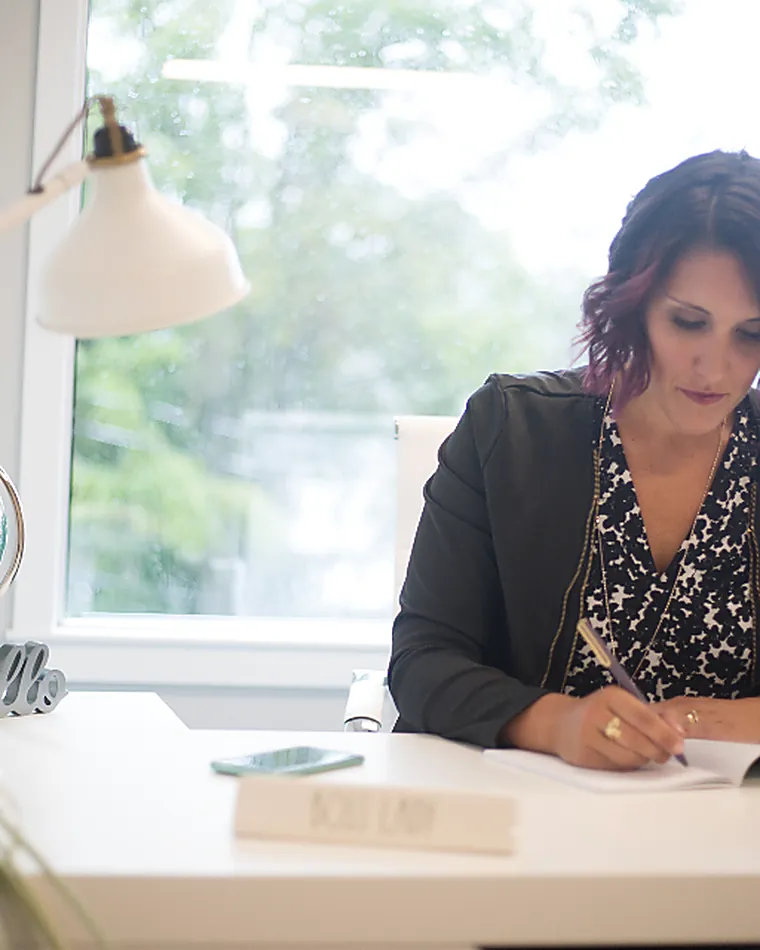 A professional at her desk taking a call