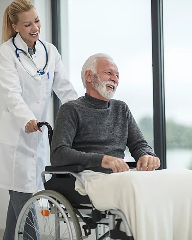 A clinician speaking with a patient in a bright consultation room