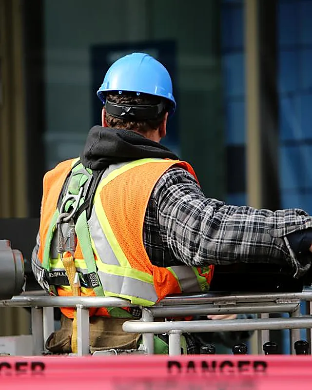 A site engineer in high visibility clothing reviewing work on a construction deck