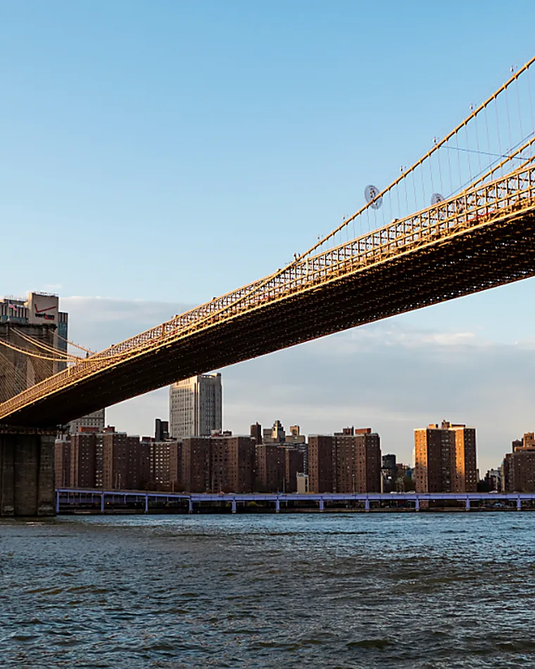 A great bridge span crossing a river at dusk