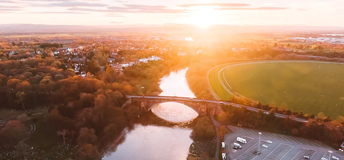 An aerial view of a river crossing at first light