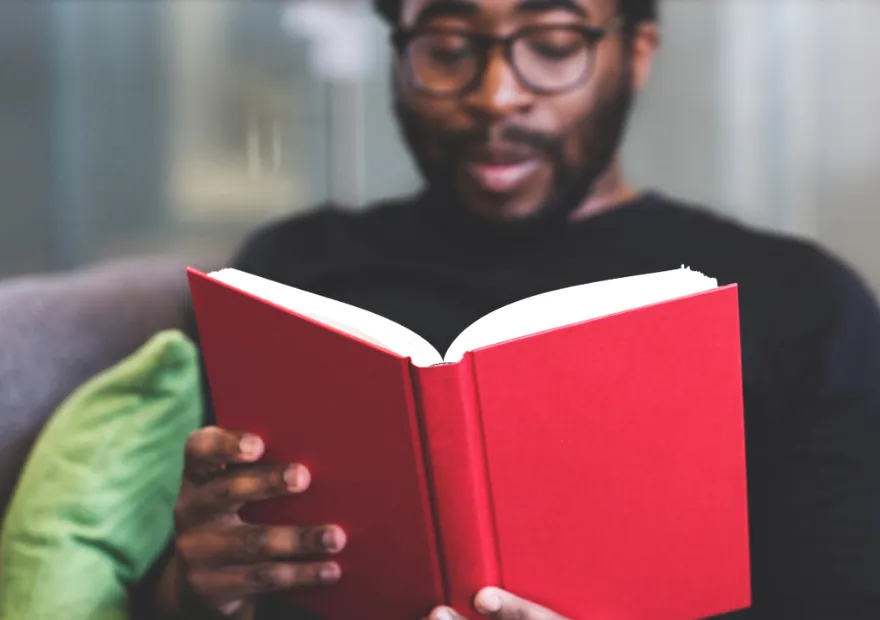 A man reading intently from a book