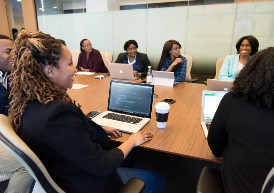 A group of colleagues working around a laptop