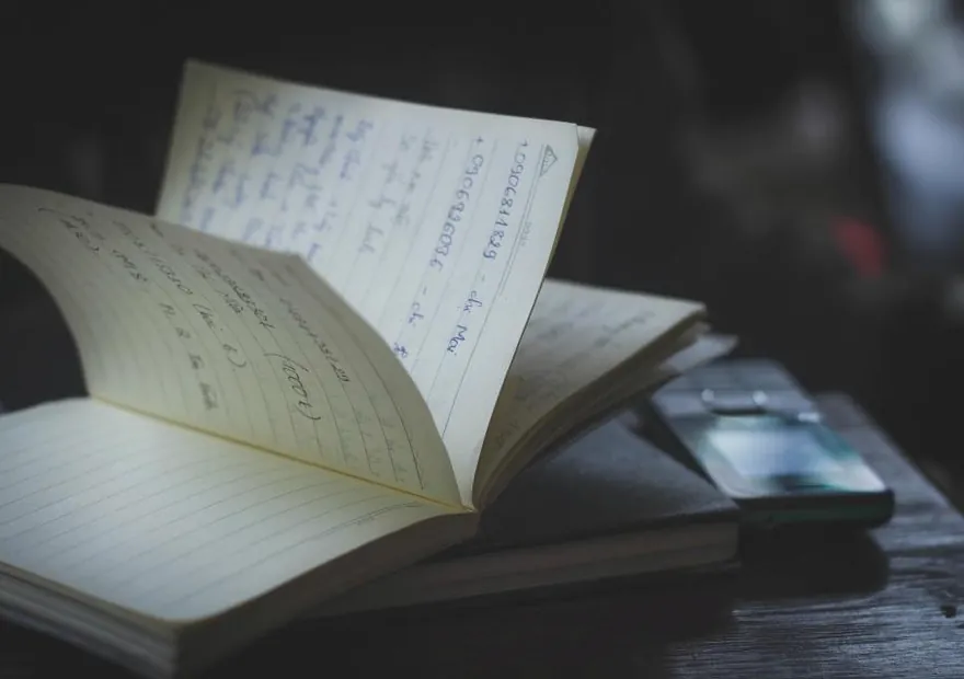 An open notebook on a desk in low light