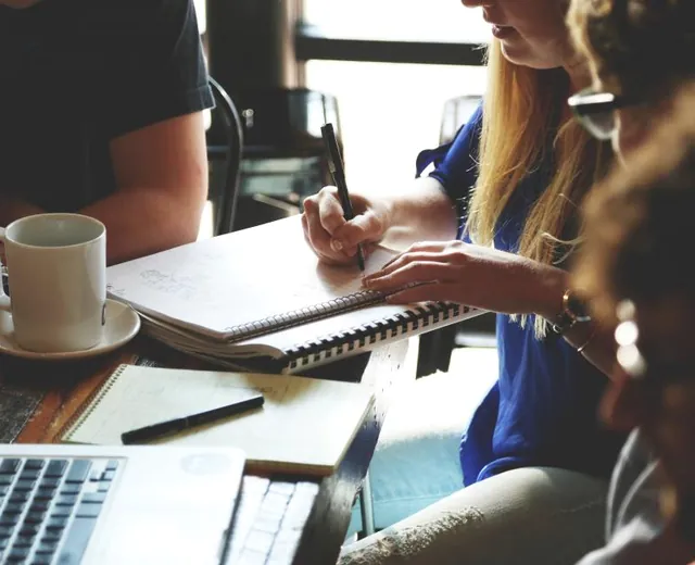 People working through material together at a table