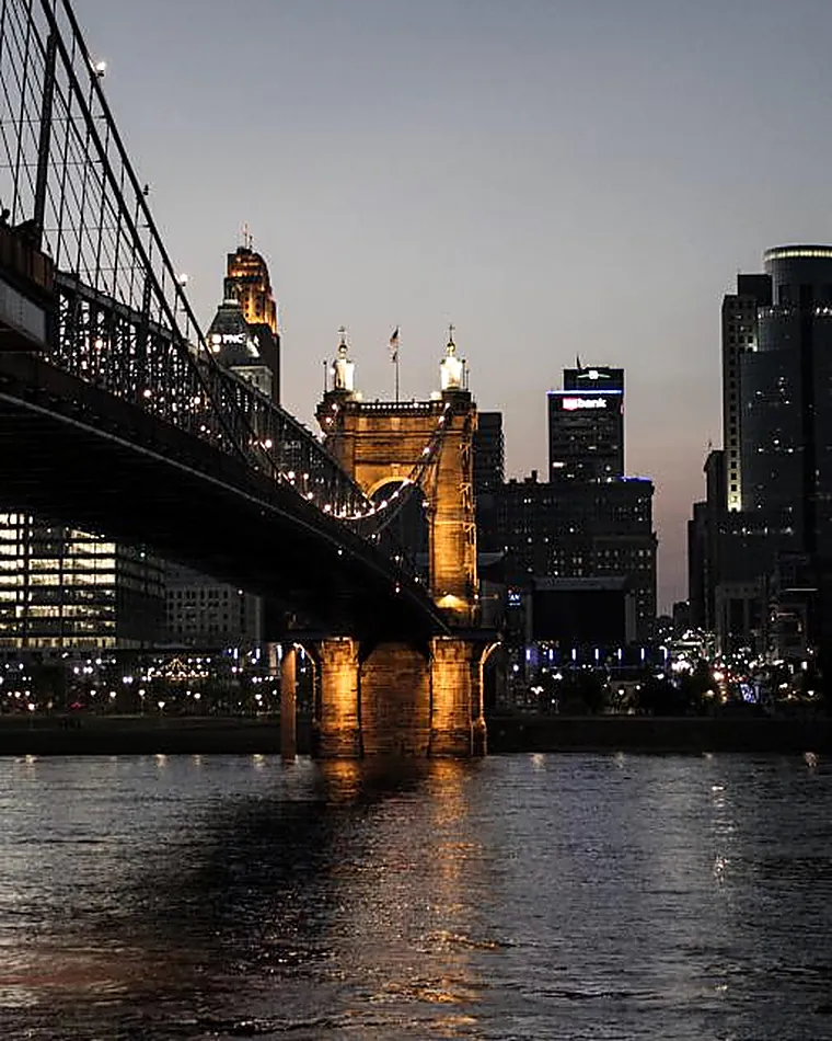 A long bridge span reaching towards a city