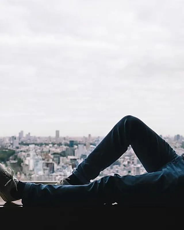 A person sitting quietly by a large window