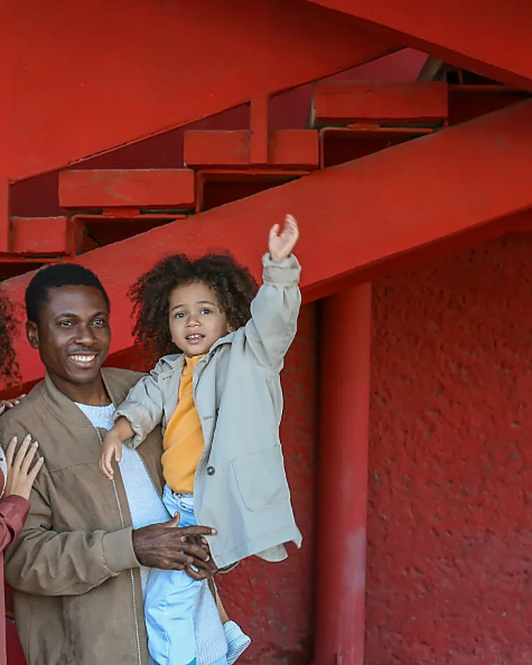Three people talking on a bright stairway